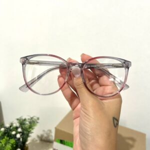 Realce seu estilo com a nossa Armação Clip On Arredondada Roxo! Este design encantador combina a forma clássica de gatinho com uma pitada de ousadia na cor rosa. Além disso, apresenta a funcionalidade prática de um clip-on, permitindo que você adicione facilmente lentes de sol quando necessário. Seja para um visual descontraído ou para um dia ensolarado, esta armação oferece elegância.